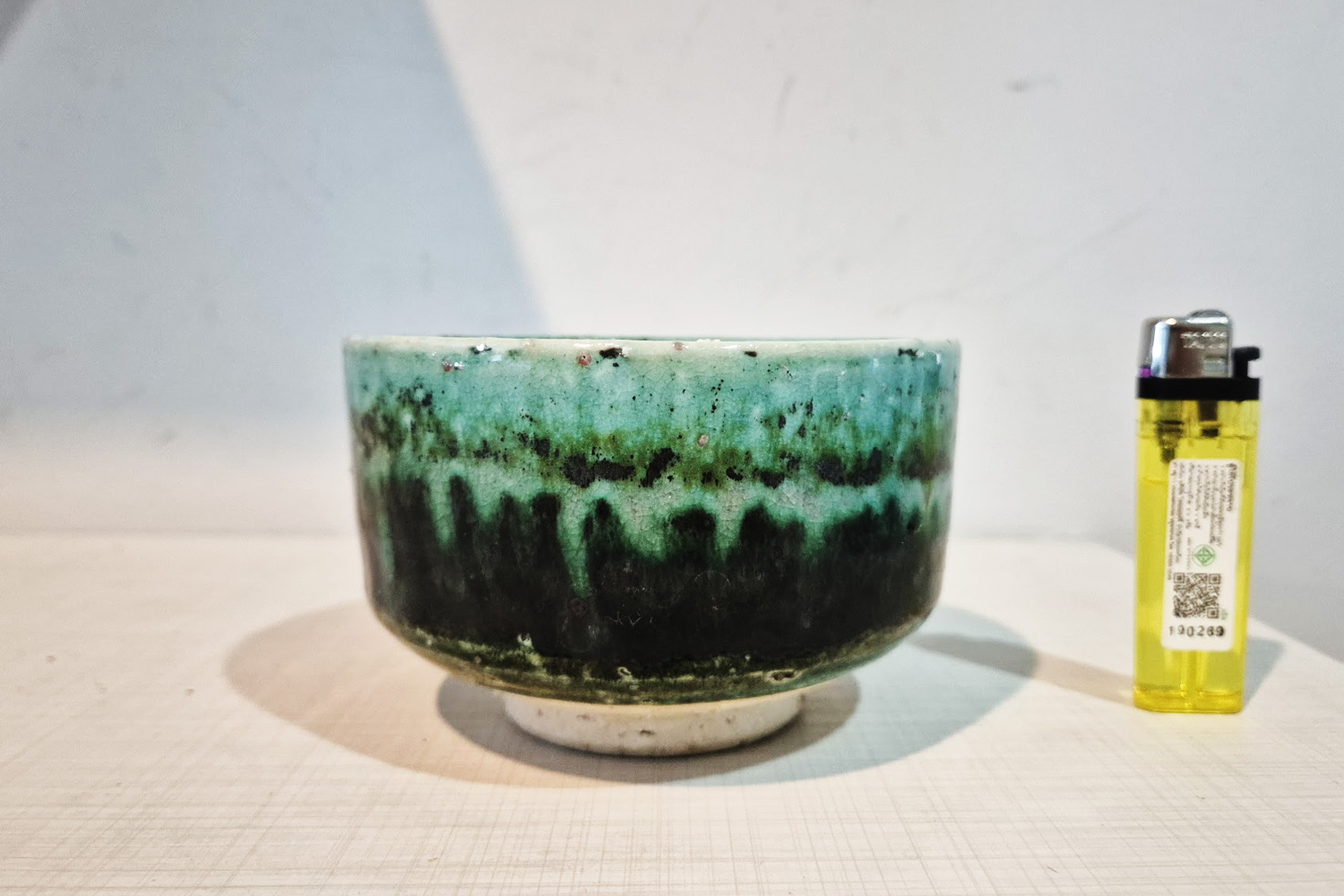 Tsuboya yachimun oribe glaze flow tea bowl with turquoise and black drip design