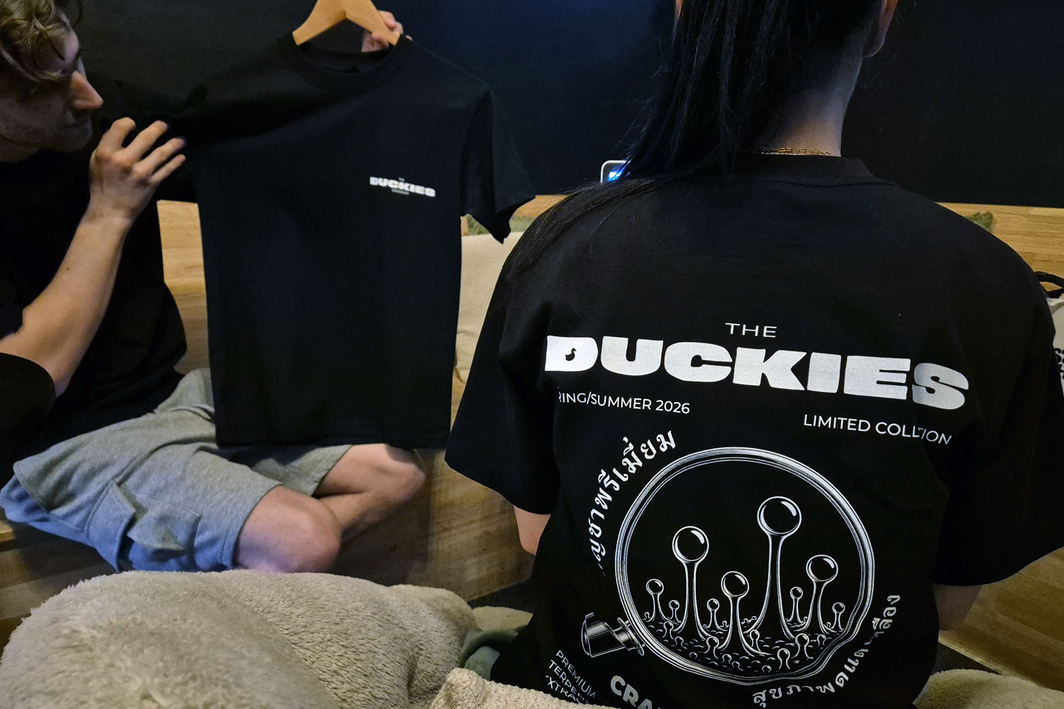 Duckies Dispensary original t-shirt with Thai-language message